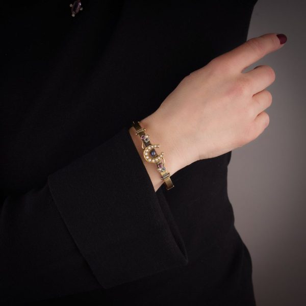 Victorian gold bangle with gemstones.
