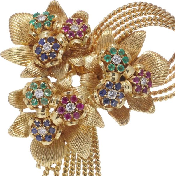 Diamond and gemstone brooch in gold.