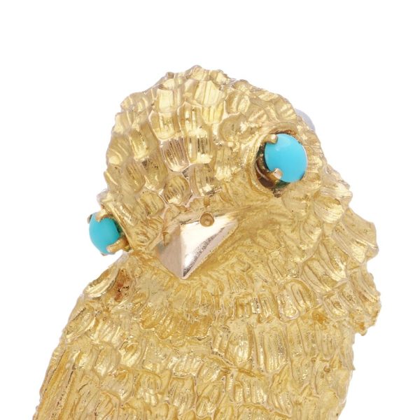 Vintage gold bird brooch with turquoise eyes.