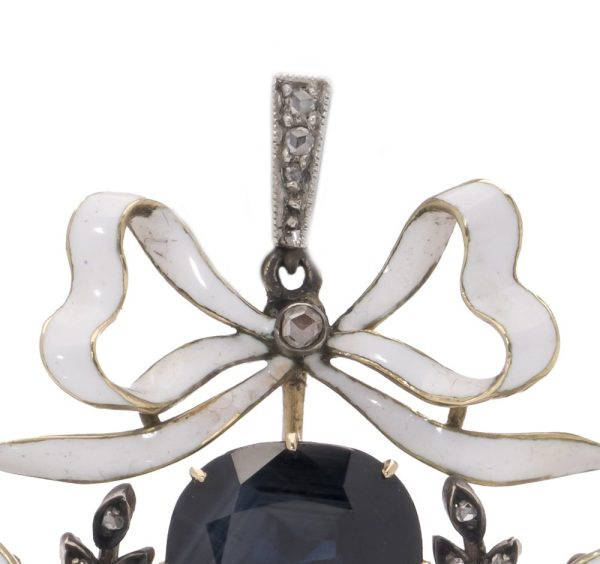 Antique diamond and sapphire pendant in gold and silver.
