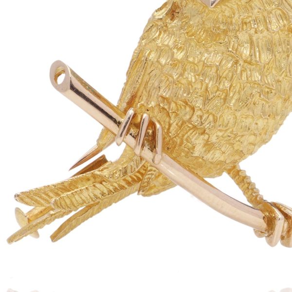 Vintage gold bird brooch with turquoise eyes.