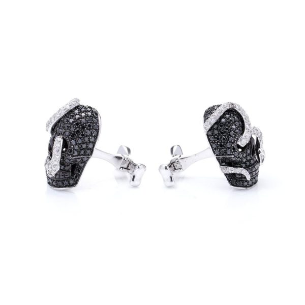 Theo Fennell gold cufflinks with black and white diamonds.