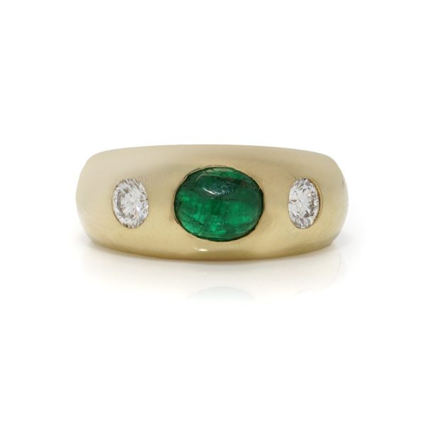 Bvlgari three-stone ring in gold with emerald and diamonds.