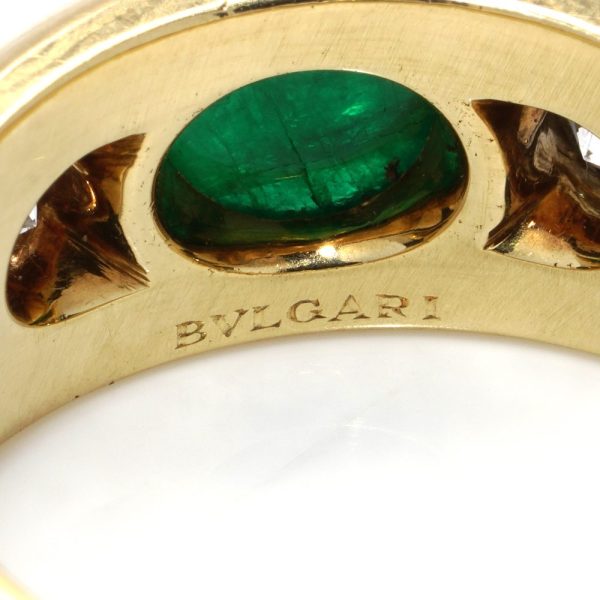 Bvlgari three-stone ring in gold with emerald and diamonds.