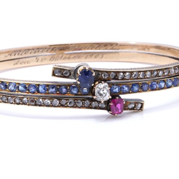 Edwardian gold bangle with diamonds, sapphires and a ruby.