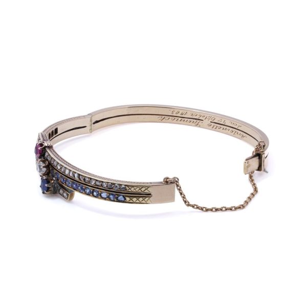Edwardian gold bangle with diamonds, sapphires and a ruby.