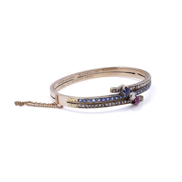 Edwardian gold bangle with diamonds, sapphires and a ruby.