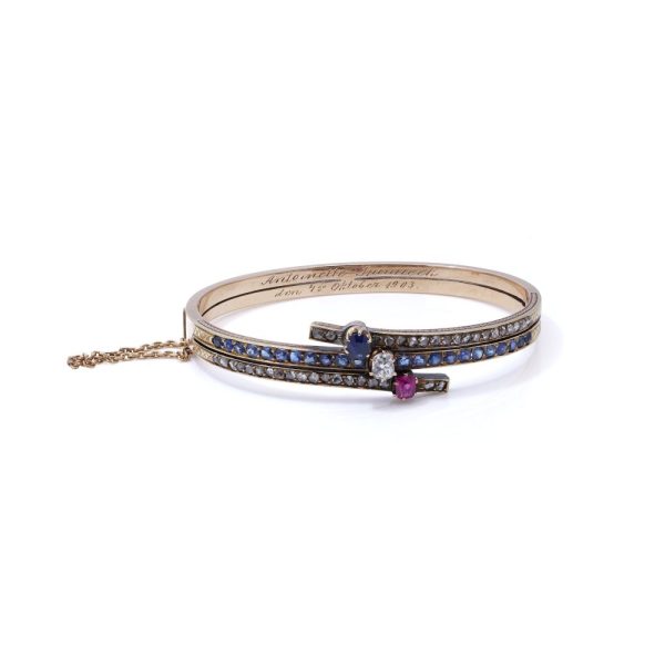 Edwardian gold bangle with diamonds, sapphires and a ruby.