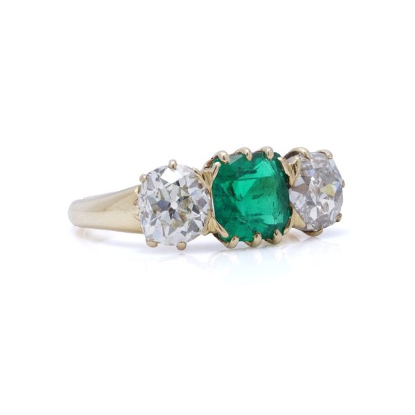 Antique emerald and diamond three-stone ring in gold.