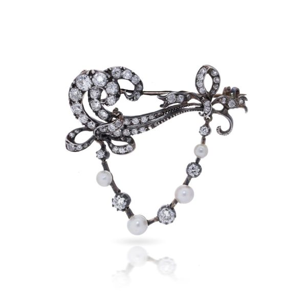 Edwardian diamond and pearl brooch in gold and silver.