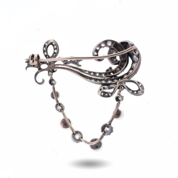 Edwardian diamond and pearl brooch in gold and silver.
