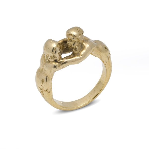 Antique gold ring with man and woman embracing.