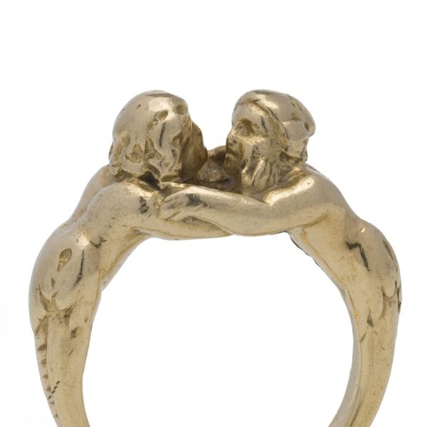 Antique gold ring with man and woman embracing.