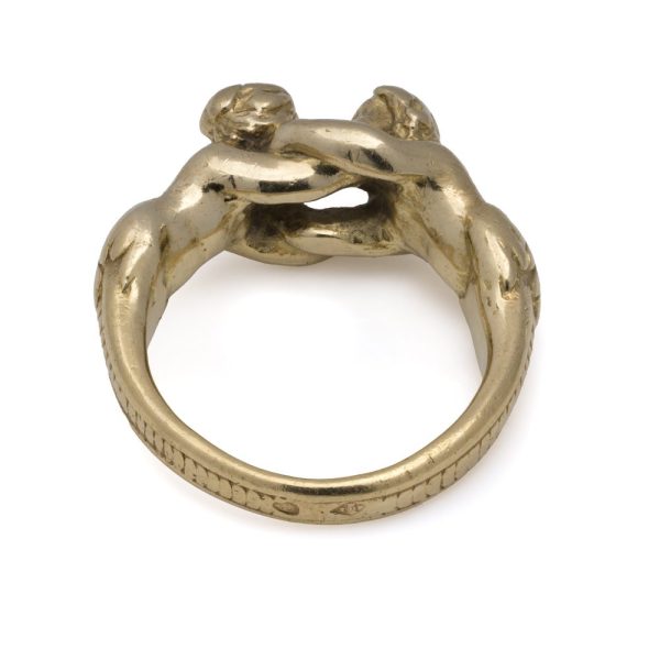 Antique gold ring with man and woman embracing.