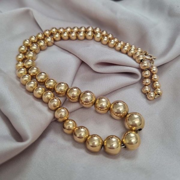 Vintage Graduating Yellow Gold Bead Necklace, underlying chain strung with polished 14ct yellow gold beads measuring from 9.5mm to 4.5mm. Circa 1930s
