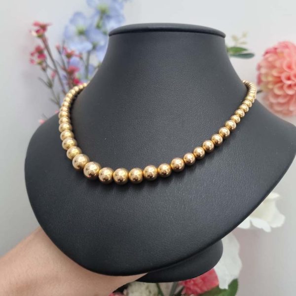Vintage Graduating Yellow Gold Bead Necklace, underlying chain strung with polished 14ct yellow gold beads measuring from 9.5mm to 4.5mm. Circa 1930s