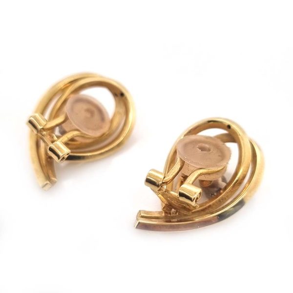 Vintage Diamond and Gold Clip Earrings by Garrards,f 14ct yellow gold swirl design clip-on earrings each with central brilliant-cut diamond. Circa 1970. Hallmarked Garrards and Co. Ltd London, date 1970