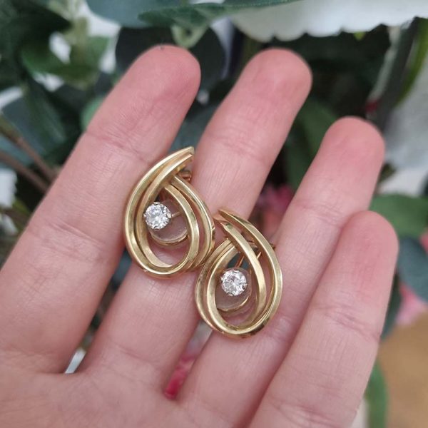 Vintage Diamond and Gold Clip Earrings by Garrards,f 14ct yellow gold swirl design clip-on earrings each with central brilliant-cut diamond. Circa 1970. Hallmarked Garrards and Co. Ltd London, date 1970