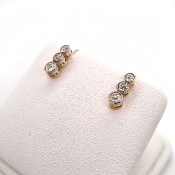 Edwardian Antique Diamond Drop Earrings, three slightly graduated old European transitional cut diamonds in platinum to 18ct yellow gold. Circa 1900