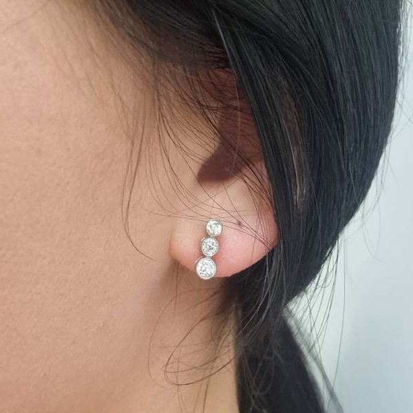 Edwardian Antique Diamond Drop Earrings, three slightly graduated old European transitional cut diamonds in platinum to 18ct yellow gold. Circa 1900