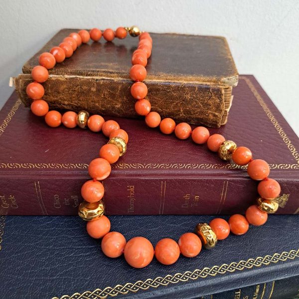 Antique Japanese Momo Coral and Gold Graduated Bead Necklace, single strand graduating orange-pink Momo coral and 18ct yellow gold disc beads with 14ct yellow gold bead clasp