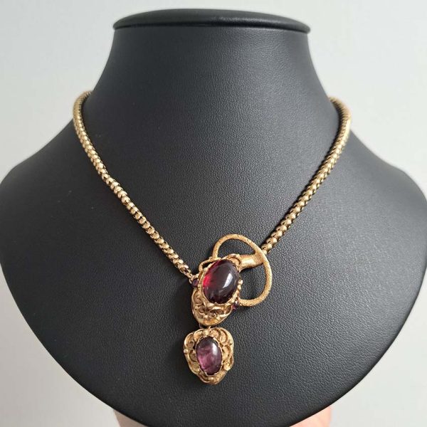Victorian Antique Garnet and Gold Snake Necklace, intricate articulated 18ct yellow gold scales to snake's head with oval cabochon garnet suspending heart shaped locket pendant with lock of hair to the reverse. Circa 1850