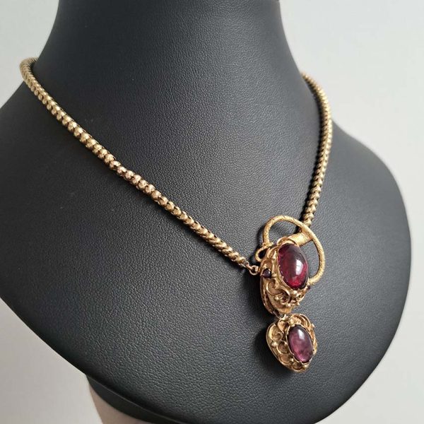 Victorian Antique Garnet and Gold Snake Necklace, intricate articulated 18ct yellow gold scales to snake's head with oval cabochon garnet suspending heart shaped locket pendant with lock of hair to the reverse. Circa 1850