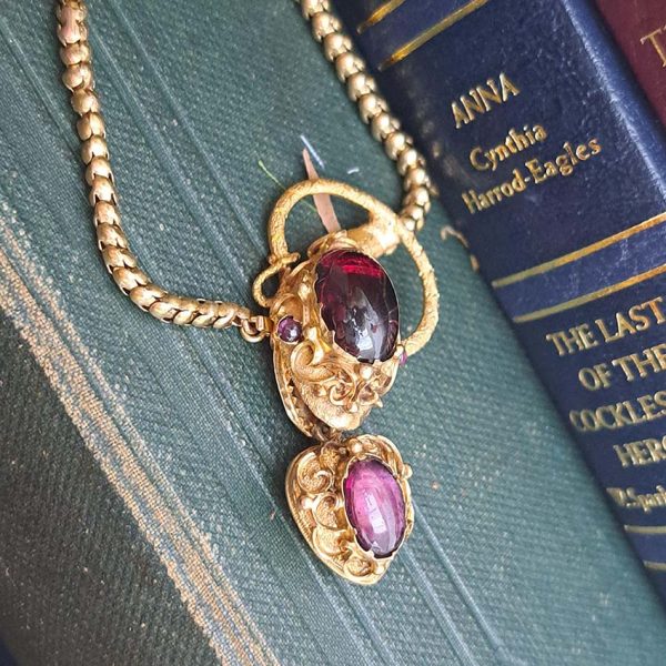 Victorian Antique Garnet and Gold Snake Necklace, intricate articulated 18ct yellow gold scales to snake's head with oval cabochon garnet suspending heart shaped locket pendant with lock of hair to the reverse. Circa 1850