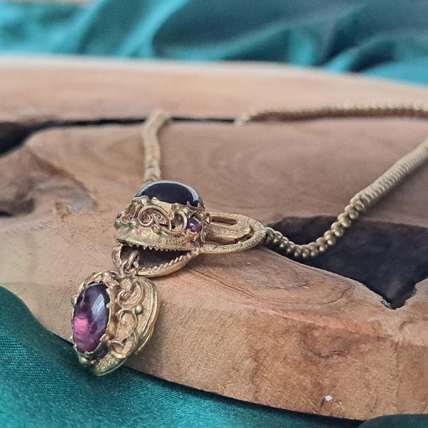 Victorian Antique Garnet and Gold Snake Necklace, intricate articulated 18ct yellow gold scales to snake's head with oval cabochon garnet suspending heart shaped locket pendant with lock of hair to the reverse. Circa 1850