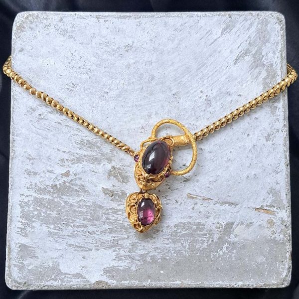 Victorian Antique Garnet and Gold Snake Necklace, intricate articulated 18ct yellow gold scales to snake's head with oval cabochon garnet suspending heart shaped locket pendant with lock of hair to the reverse. Circa 1850