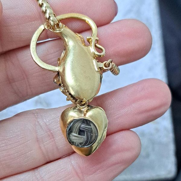 Victorian Antique Garnet and Gold Snake Necklace, intricate articulated 18ct yellow gold scales to snake's head with oval cabochon garnet suspending heart shaped locket pendant with lock of hair to the reverse. Circa 1850