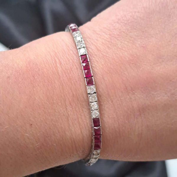 Art Deco Charles Holl 5ct Ruby and Diamond Line Bracelet, set with alternating sections of square French cut rubies and sparkling transitional cut diamonds in platinum and 18ct white gold