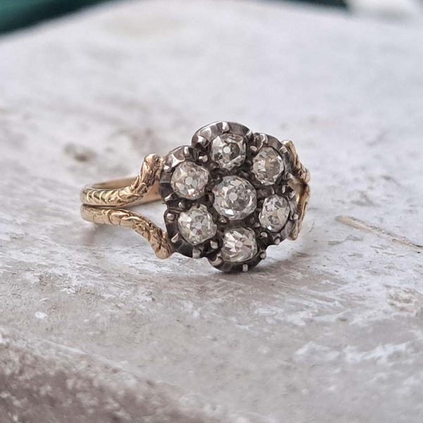 Antique Old Cut Diamond Flower Cluster Engagement Ring, 0.80 carat total, old mine-cut diamond surrounded by six diamonds in timeless floral design in yellow gold with decorative split shoulders