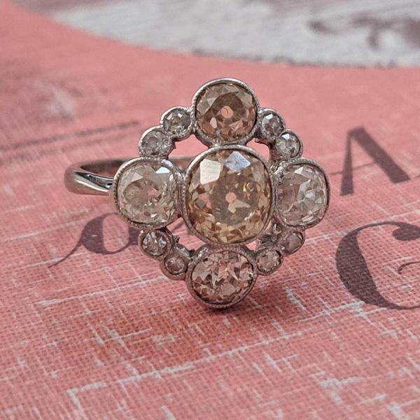 Antique 3.7cts Fancy Champagne Diamond Quatrefoil Ring, 1.57ct old mine-cut champagne diamond surrounded by four further old mine-cut diamonds of varying champagne hues arranged at the four compass points, with smaller old-cut diamond accents between in platinum and 18ct white gold