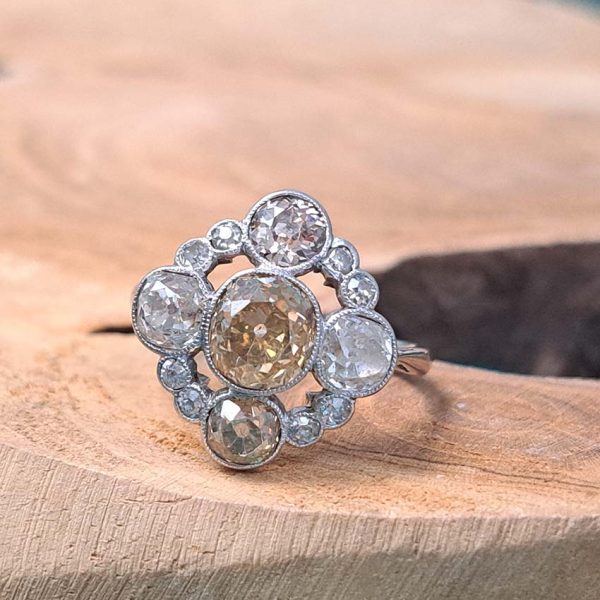 Antique 3.7cts Fancy Champagne Diamond Quatrefoil Ring, 1.57ct old mine-cut champagne diamond surrounded by four further old mine-cut diamonds of varying champagne hues arranged at the four compass points, with smaller old-cut diamond accents between in platinum and 18ct white gold
