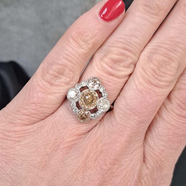 Antique 3.7cts Fancy Champagne Diamond Quatrefoil Ring, 1.57ct old mine-cut champagne diamond surrounded by four further old mine-cut diamonds of varying champagne hues arranged at the four compass points, with smaller old-cut diamond accents between in platinum and 18ct white gold