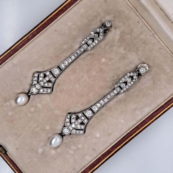 Antique Art Deco Natural Pearl and Diamond Drop Earrings, graduated geometric designs studded with 2 carats of sparkling diamonds leading to natural pearl pendant drops in platinum
