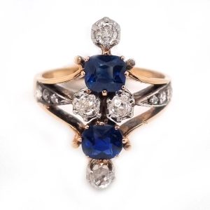 Victorian Antique Sapphire and Diamond Dress Ring, two cushion cut sapphires accented with four old mine-cut diamonds in 18ct yellow gold