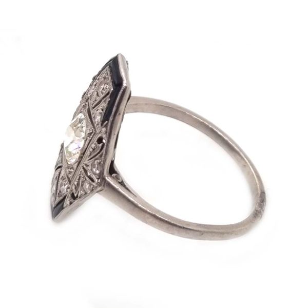 Art Deco Old Cut Diamond and Onyx Cluster Plaque Ring, 0.70ct old mine-cut diamond within tapered geometric surround of sparkling diamonds accented with rich black onyx in platinum. Circa 1920s