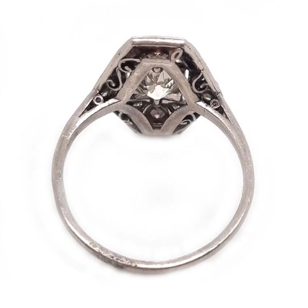 Art Deco Old Cut Diamond and Onyx Cluster Plaque Ring, 0.70ct old mine-cut diamond within tapered geometric surround of sparkling diamonds accented with rich black onyx in platinum. Circa 1920s