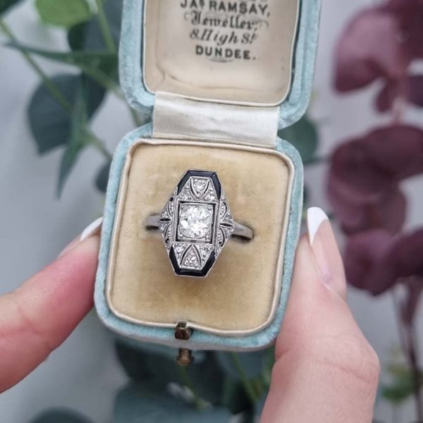 Art Deco Old Cut Diamond and Onyx Cluster Plaque Ring, 0.70ct old mine-cut diamond within tapered geometric surround of sparkling diamonds accented with rich black onyx in platinum. Circa 1920s