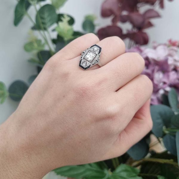 Art Deco Old Cut Diamond and Onyx Cluster Plaque Ring, 0.70ct old mine-cut diamond within tapered geometric surround of sparkling diamonds accented with rich black onyx in platinum. Circa 1920s