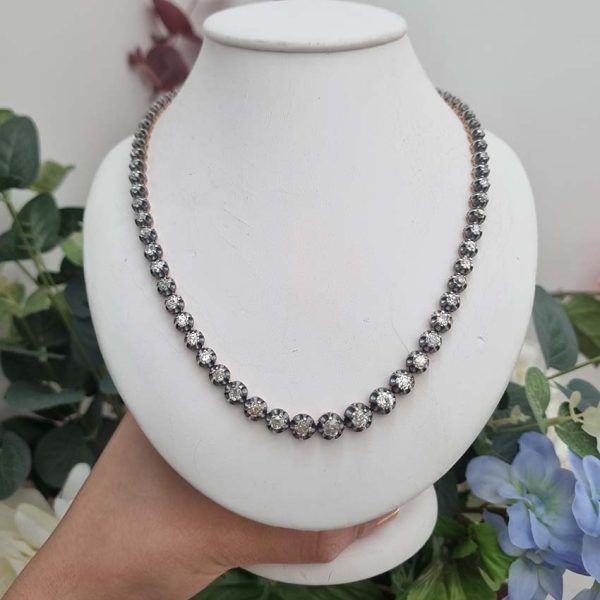 Antique 10.7ct Old Cut Diamond Line Necklace, 73 graduating old mine-cut diamonds in individual crown settings in silver upon yellow gold, 43.3cm long