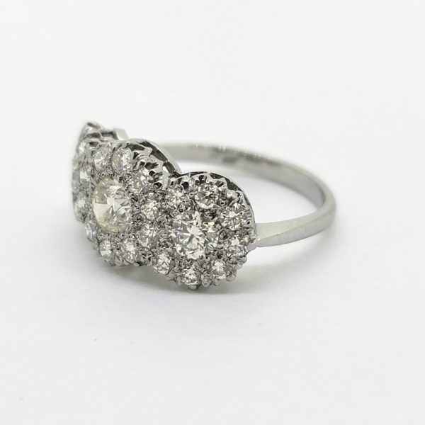 Contemporary Triple Diamond Cluster Three Stone Ring in Platinum, three principal diamonds all within diamond surrounds, 1.85 carat total
