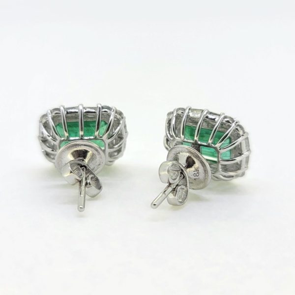 3.63ct Emerald and Diamond Cluster Earrings, 3.63cts green emeralds within 1.02cts brilliant and baguette-cut diamond surrounds in 18ct white gold