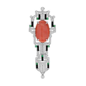 Art Deco Inspired Coral Onyx and Diamond Brooch, vivid orange 6.32ct oval coral within diamond geometric frame with contrasting black onyx and green emerald accents in 14ct white gold