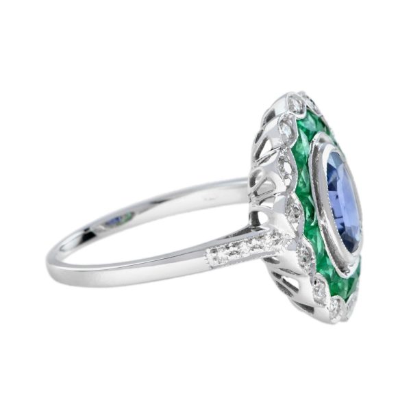 1.50ct Ceylon Sapphire with Emerald and Diamond Cluster Engagement Ring, 1.50ct oval cut Ceylon Sapphire surrounded by emerald halo and outer border of sparkling diamonds in 18ct white gold