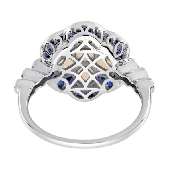 1ct Opal and Sapphire Cluster Engagement Ring with Diamond Shoulders, cabochon-cut opals surrounded by calibre French-cut blue sapphire border in 14ct white gold with diamond set shoulders