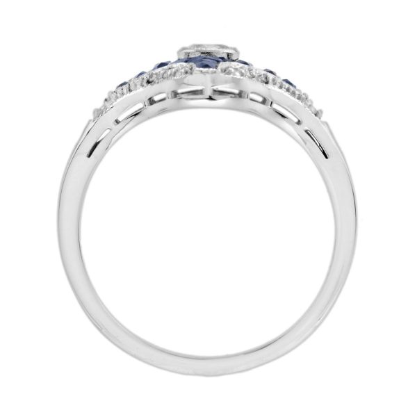 Diamond and Sapphire Navette Cluster Plaque Ring, central sparkling diamond surrounded by calibre French-cut blue sapphires within outer diamond border in 14ct white gold