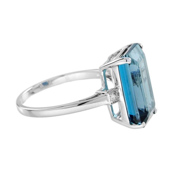 8.80ct Emerald Cut Blue Topaz Solitaire Engagement Ring, single stone deep greenish-blue London topaz with sparkling diamond to each side in 18ct white gold